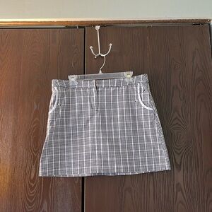 Izod of stretch black/ white/beige plaid skorts with black undershorts. Size 10.